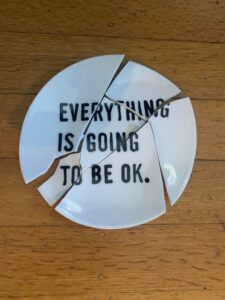 Broken plate with the words "Everything is going to be OK."