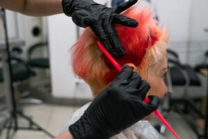 woman gets hair dyed bright red