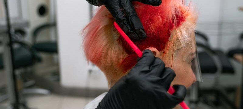 woman gets hair dyed bright red